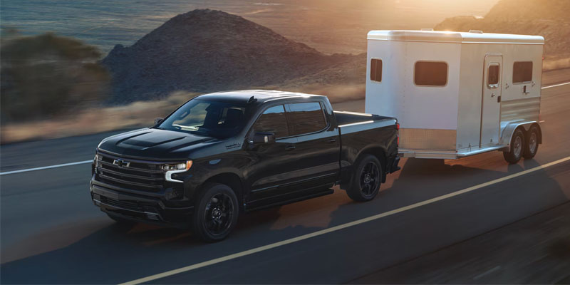 A 2026 Chevrolet Silverado 1500 tows a trailer in MichIgan